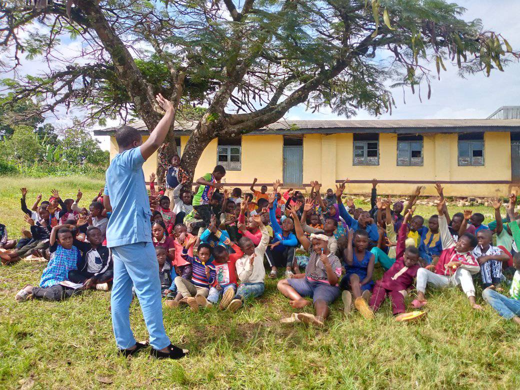 Story Telling Session with children under a tree in Mbengwi