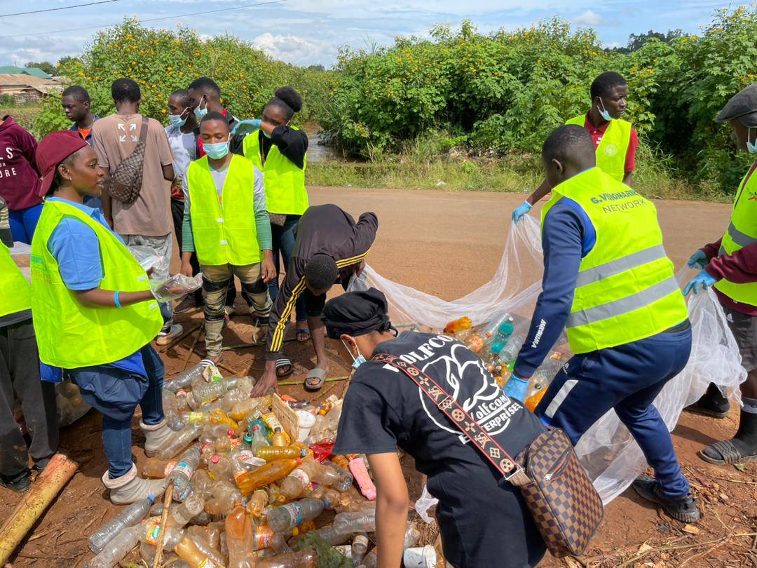 World clean-up day 2023, Xhuma Africa Volunteers removing bottles from a stream in Bamenda